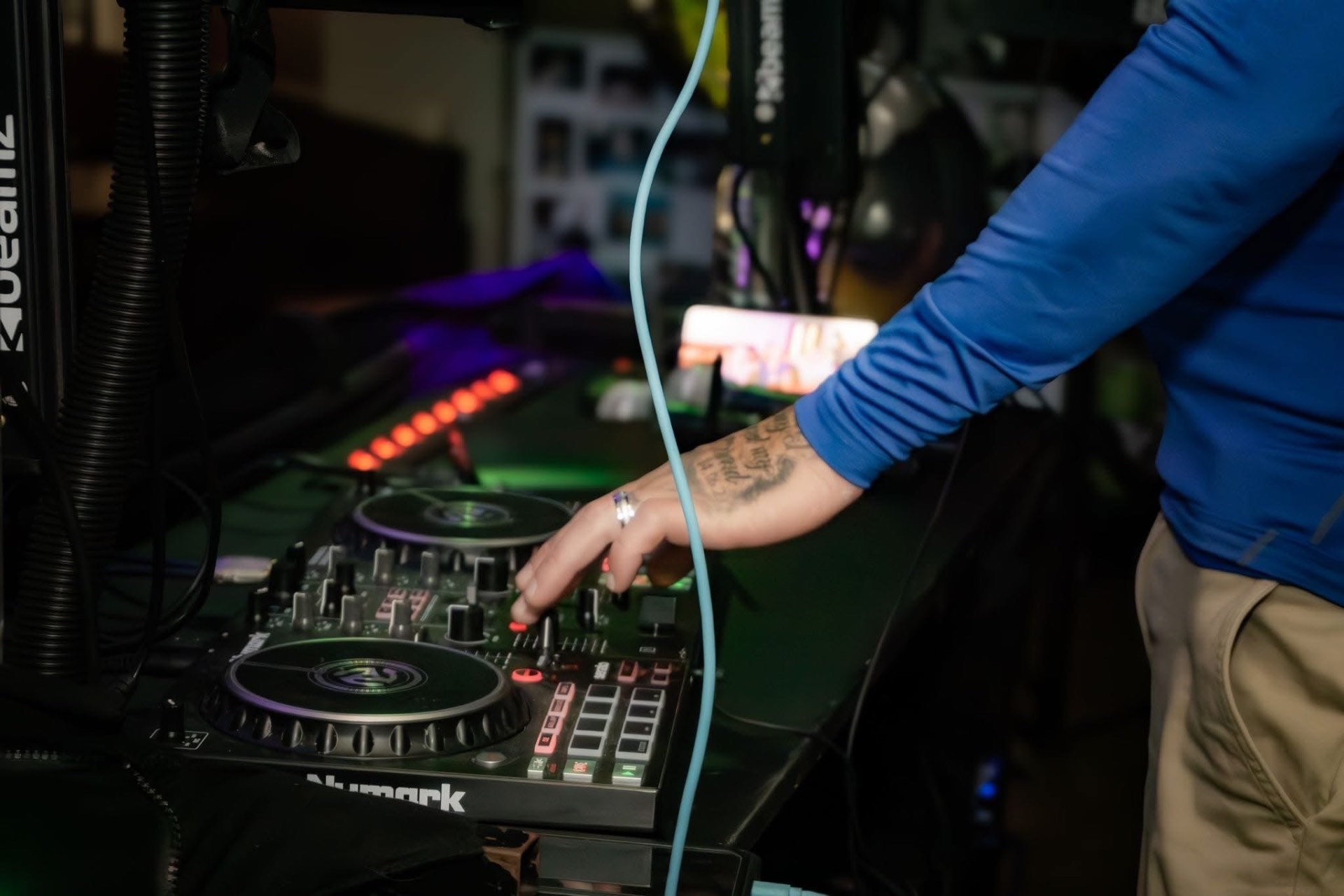 Hand on the Numark mixer mid-set