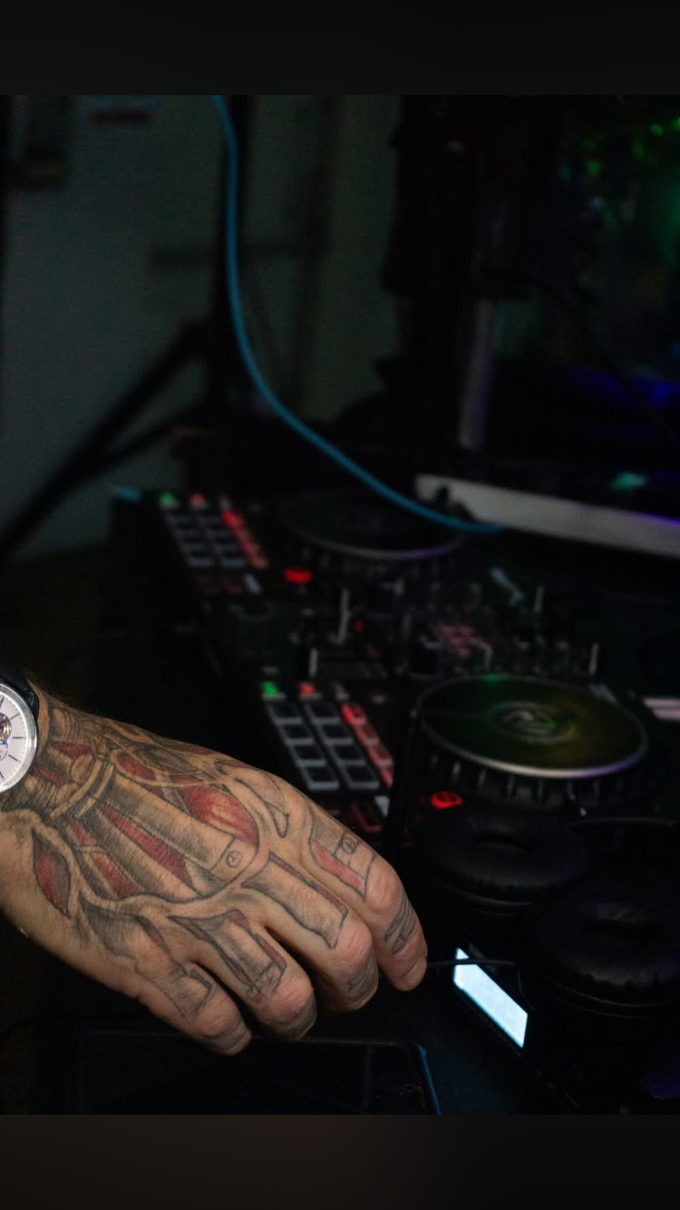 Tattooed hand on the controller
